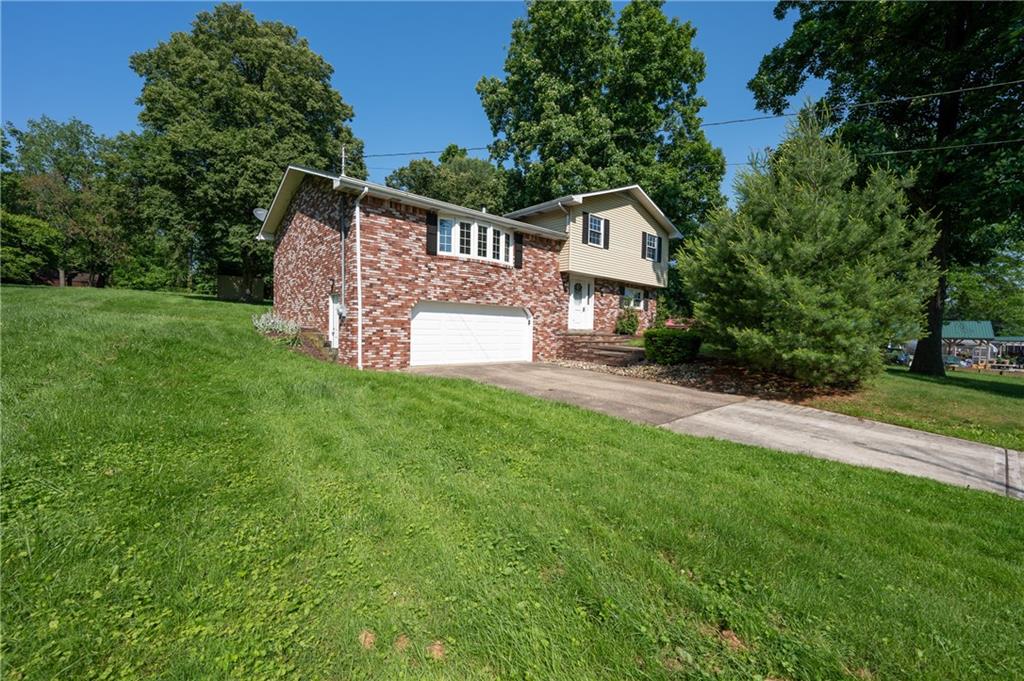 756 Arona Road New Stanton, PA 15672 - Photo 2 of 35 a front view of a house with yard and green space