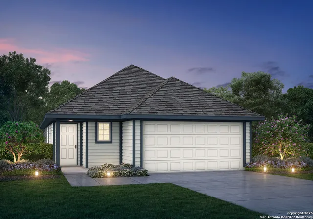 a front view of a house with a garden and yard