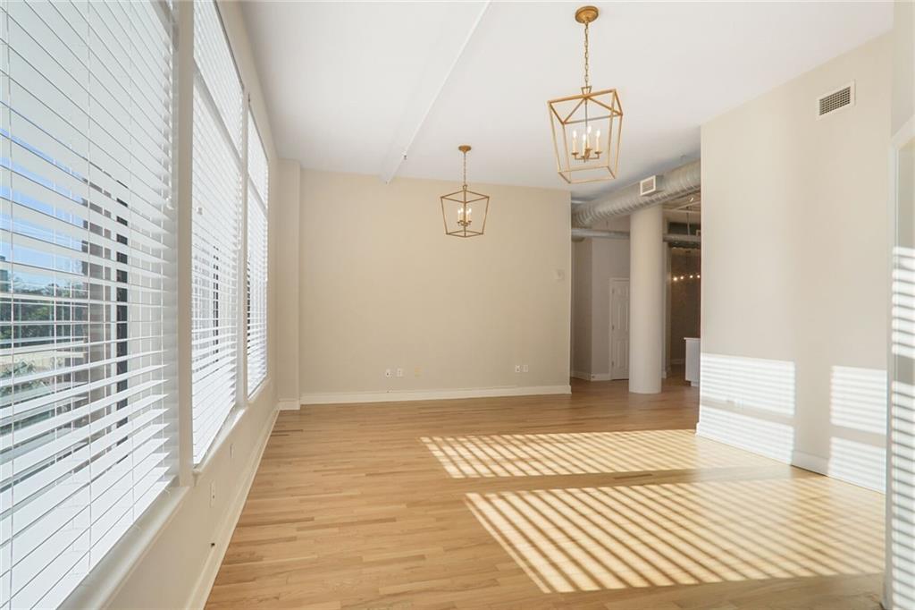 3820 Roswell Road Northeast, Unit 317 Atlanta, GA 30342 - Photo 15 of 29 a view of a room with wooden floor and windows