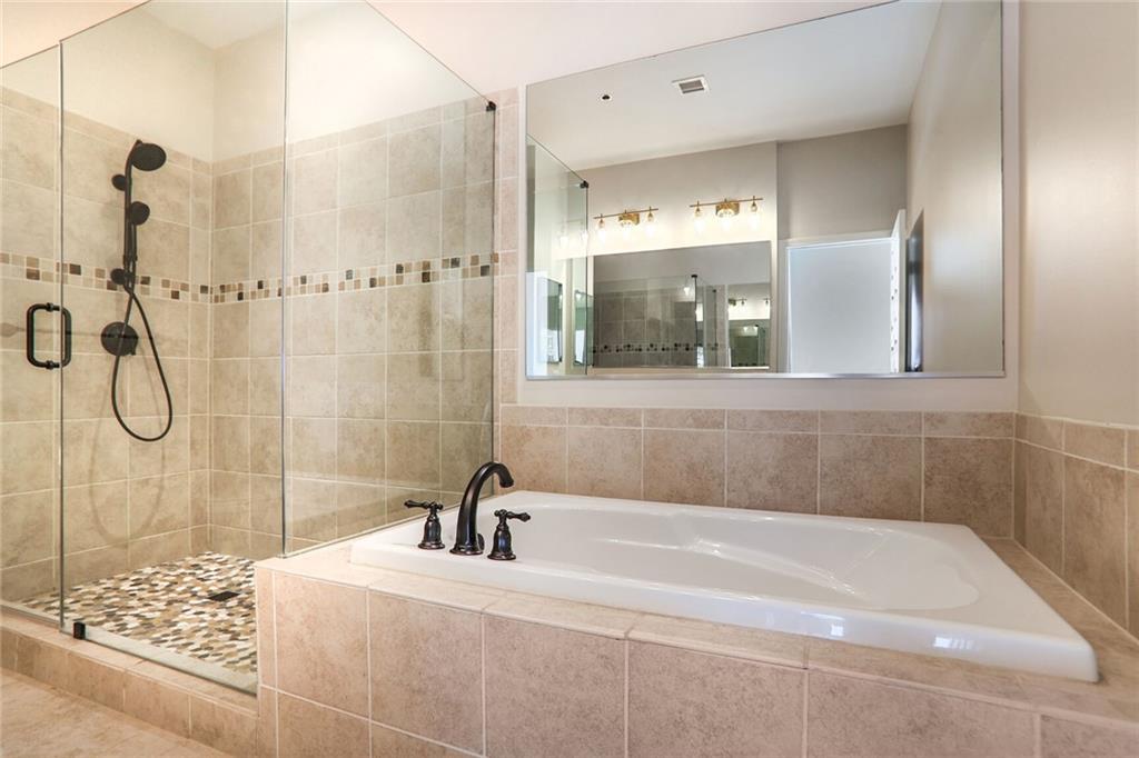 3820 Roswell Road Northeast, Unit 317 Atlanta, GA 30342 - Photo 20 of 29 a bathroom with a bathtub and a shower