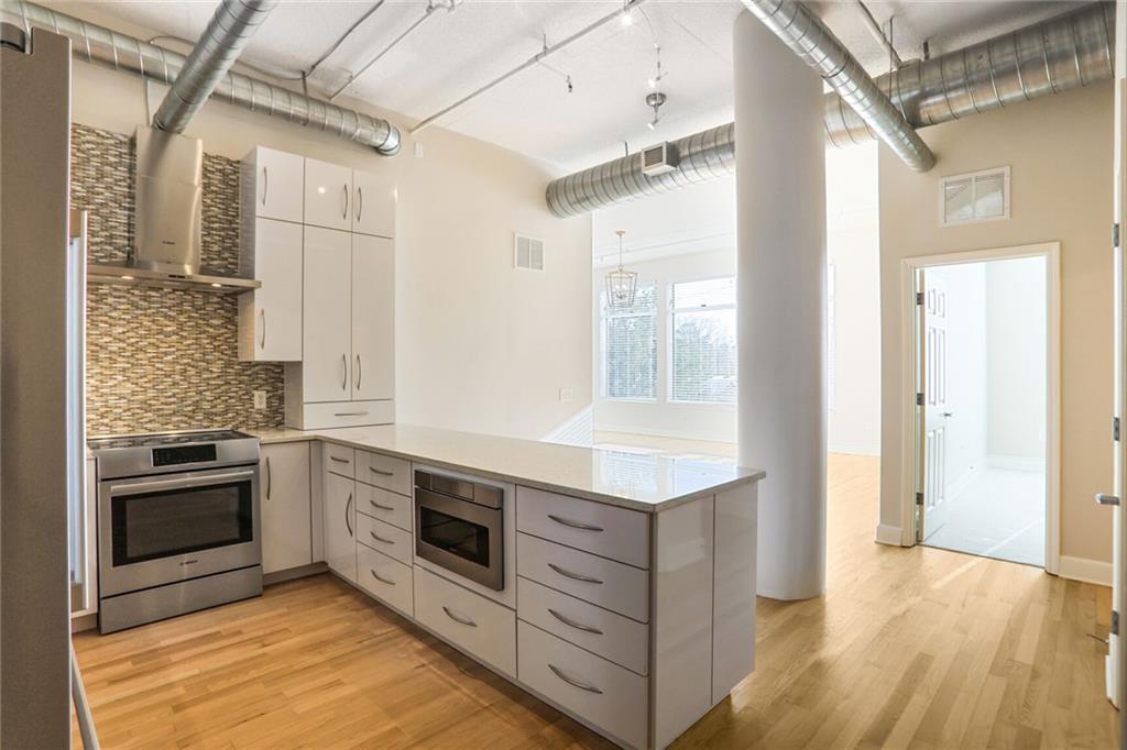 3820 Roswell Road Northeast, Unit 317 Atlanta, GA 30342 - Photo 6 of 29 a kitchen with stainless steel appliances granite countertop a stove and a refrigerator