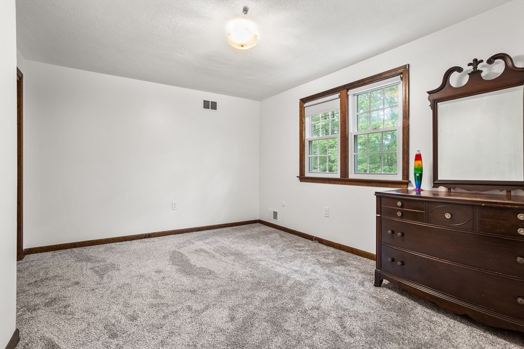 101 Drummer Road, Unit 101 Acton, MA 01720 - Photo 14 of 24 an empty room with windows