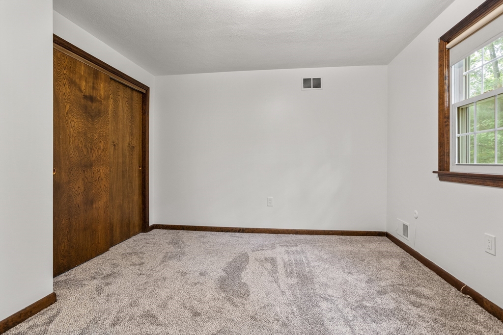 101 Drummer Road, Unit 101 Acton, MA 01720 - Photo 15 of 24 an empty room with windows