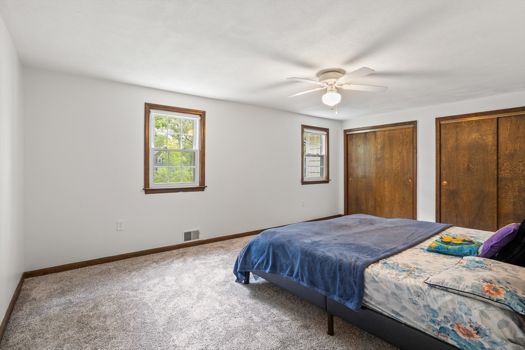 101 Drummer Road, Unit 101 Acton, MA 01720 - Photo 17 of 24 a bedroom with a bed and a window