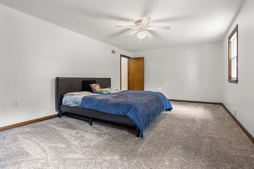 101 Drummer Road, Unit 101 Acton, MA 01720 - Photo 18 of 24 a spacious bedroom with a bed and window