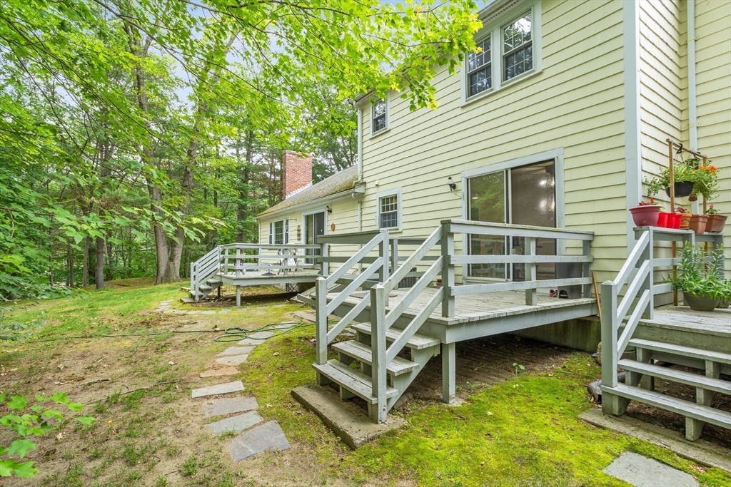 101 Drummer Road, Unit 101 Acton, MA 01720 - Photo 20 of 24 a view of a house with wooden deck front of house