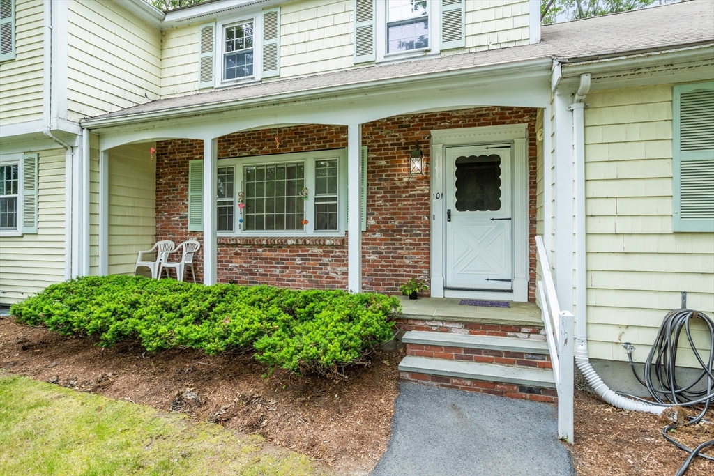101 Drummer Road, Unit 101 Acton, MA 01720 - Photo 3 of 24 a front view of a house with a garden