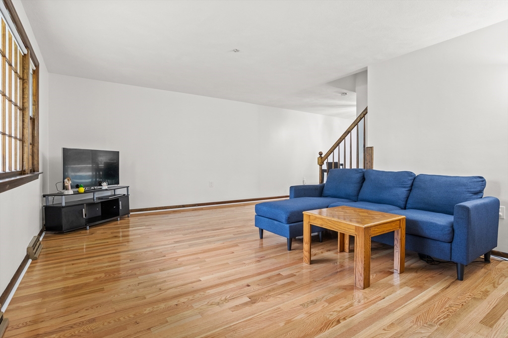 101 Drummer Road, Unit 101 Acton, MA 01720 - Photo 4 of 24 a living room with furniture and a flat screen tv