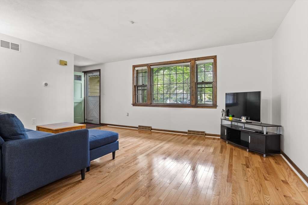 101 Drummer Road, Unit 101 Acton, MA 01720 - Photo 5 of 24 a living room with furniture and a flat screen tv