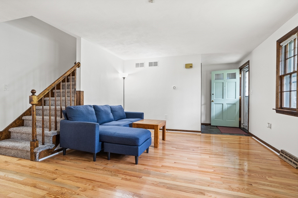 101 Drummer Road, Unit 101 Acton, MA 01720 - Photo 6 of 24 a living room with furniture and a wooden floor