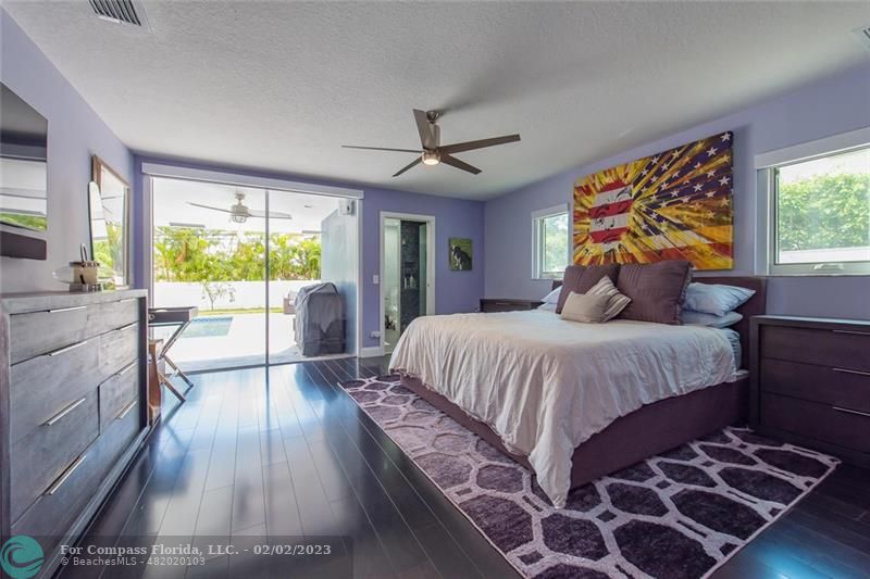 930 Northwest 4th Court Boca Raton, FL 33432 - Photo 19 of 28 a bedroom with a bed and a large window