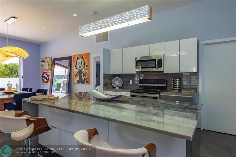 930 Northwest 4th Court Boca Raton, FL 33432 - Photo 3 of 28 a kitchen with stainless steel appliances granite countertop a sink a stove microwave and cabinets