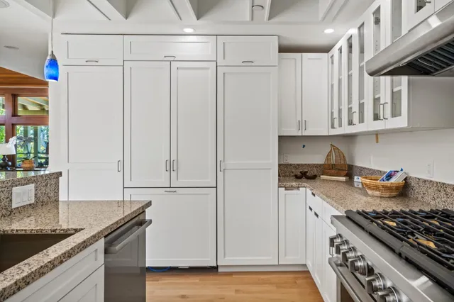 a kitchen with stainless steel appliances granite countertop a stove and a sink