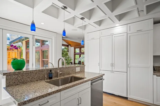 a kitchen with kitchen island granite countertop a oven a counter space and stainless steel appliances