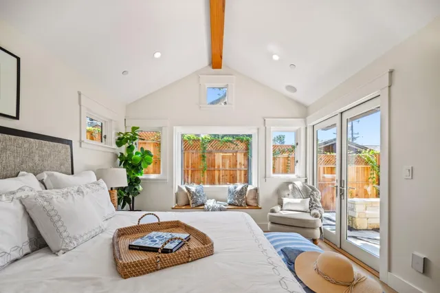 a bedroom with furniture and a large window