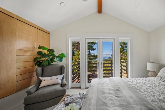 a bedroom with a large bed and a large window
