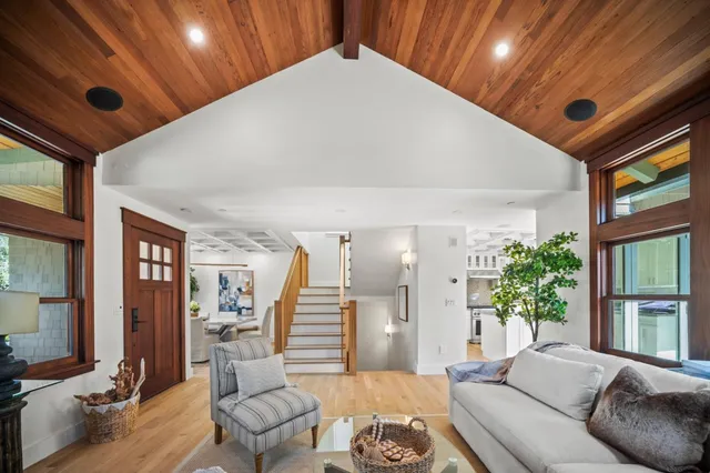 a living room with furniture and potted plants