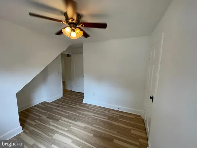 a view of empty room with window and chandelier