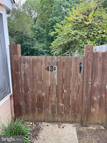 a wooden fence with trees in the background