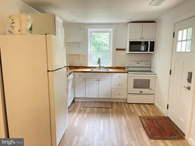 a kitchen with stainless steel appliances a refrigerator and a stove top oven