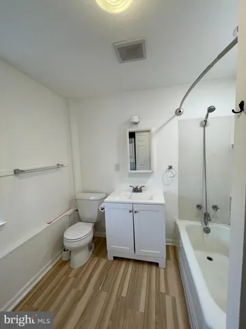 a bathroom with a sink a toilet and bathtub