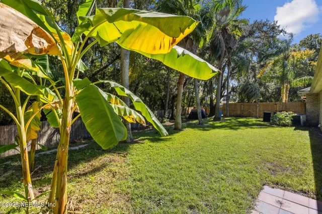 a view of a backyard with a table and chairs