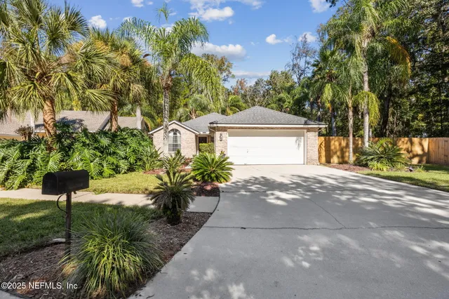 a front view of a house with a yard and a garage