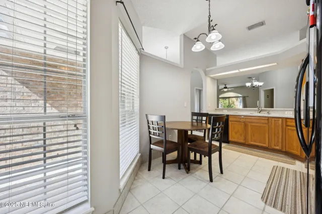 a view of a dining room with furniture and a chandelier