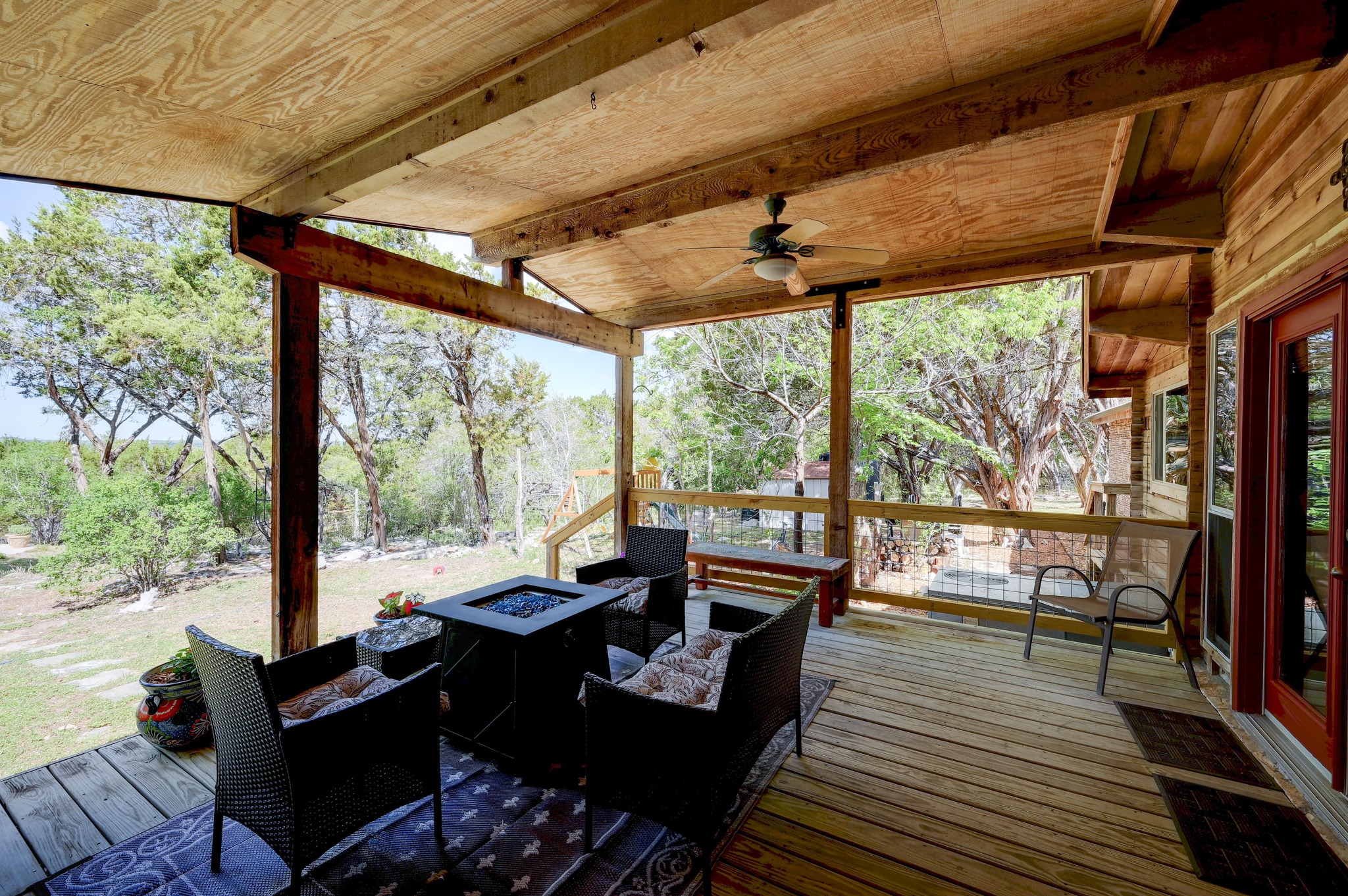 900 Box Canyon Road Wimberley, TX 78676 - Photo 34 of 40 Wooden deck with a fire pit and a ceiling fan