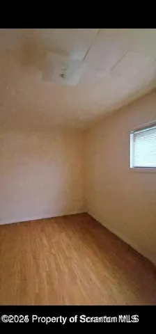 a view of an empty room and a window
