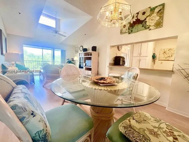 a living room with dining table and a table with garden view