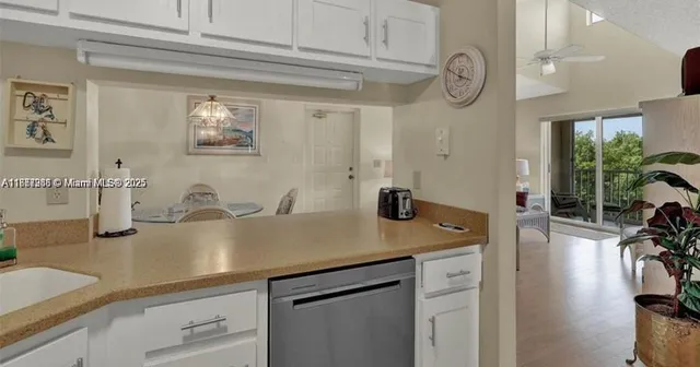 a view of a kitchen sink and cabinets