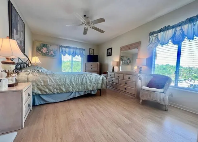 a bedroom with a bed window and a dresser