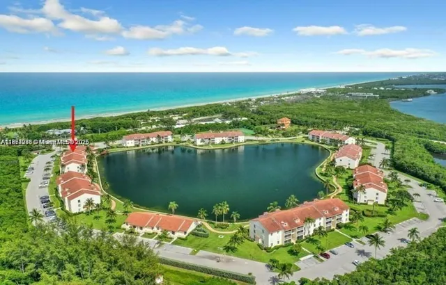 an aerial view of water body with boats and residential houses with outdoor space