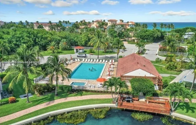 a view of a swimming pool and lounge chairs in the patio