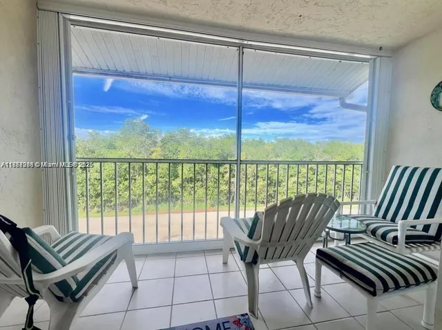 a balcony view with a seating space