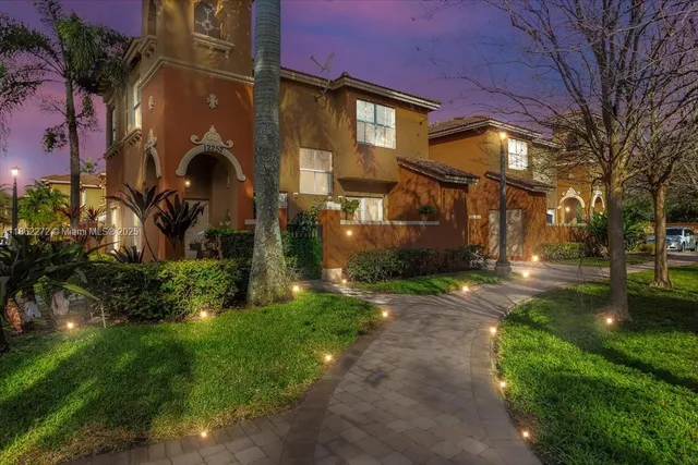 a front view of a house with a yard