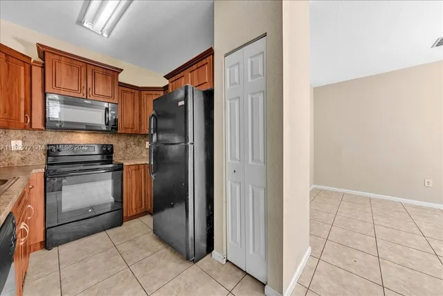 a kitchen with a refrigerator sink and microwave