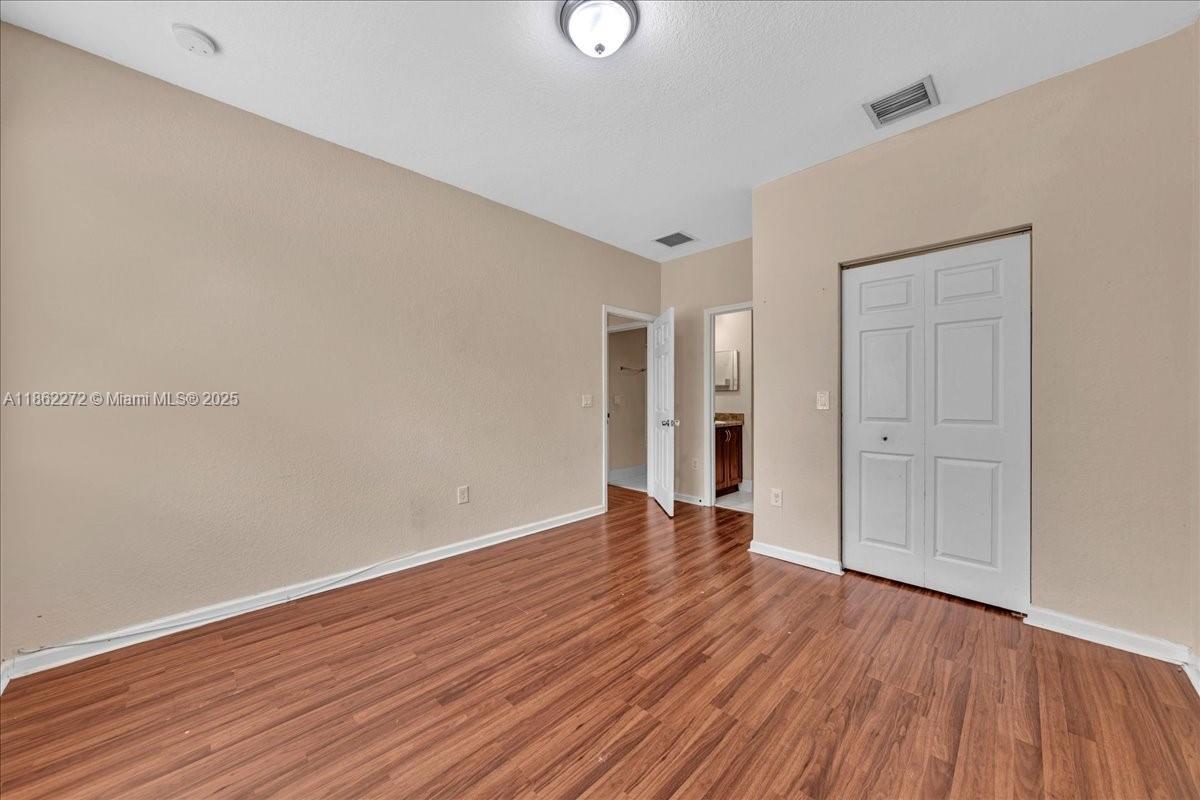 12252 Southwest 25th Court, Unit 1614 Miramar, FL 33025 - Photo 26 of 46 a view of an empty room with wooden floor