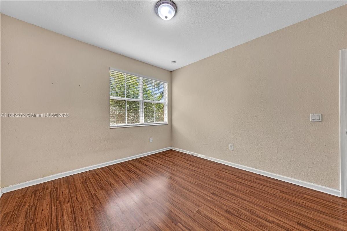 12252 Southwest 25th Court, Unit 1614 Miramar, FL 33025 - Photo 28 of 46 an empty room with wooden floor and windows
