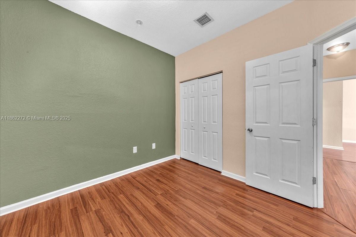 12252 Southwest 25th Court, Unit 1614 Miramar, FL 33025 - Photo 34 of 46 a view of empty room with wooden floor