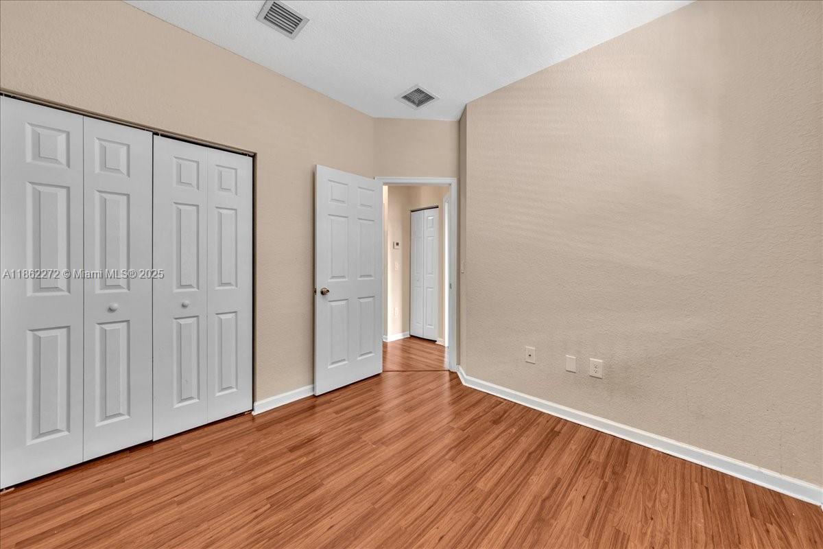 12252 Southwest 25th Court, Unit 1614 Miramar, FL 33025 - Photo 35 of 46 a view of an empty room with wooden floor