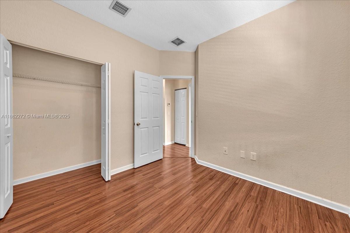 12252 Southwest 25th Court, Unit 1614 Miramar, FL 33025 - Photo 36 of 46 a view of an empty room with wooden floor