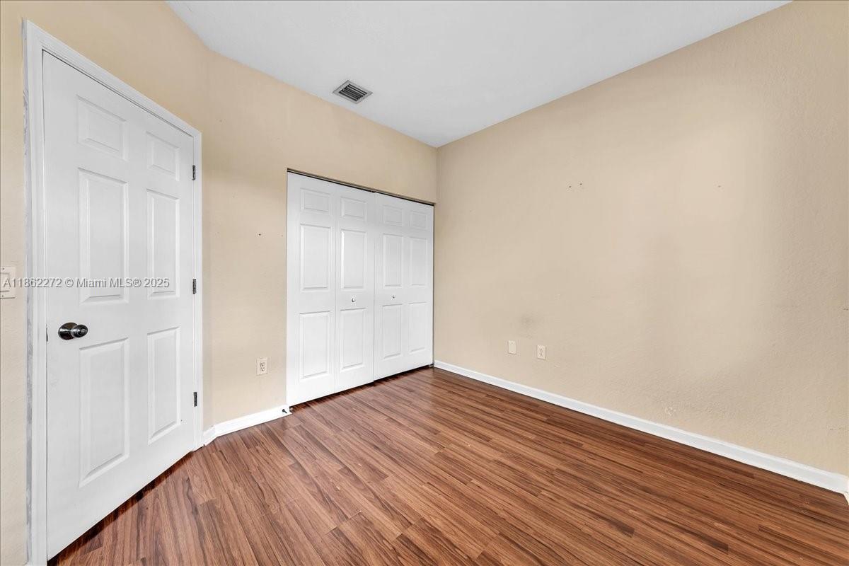 12252 Southwest 25th Court, Unit 1614 Miramar, FL 33025 - Photo 38 of 46 a view of an empty room with wooden floor