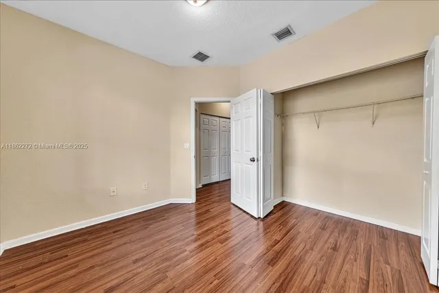 a bathroom with a granite countertop sink a mirror and a toilet