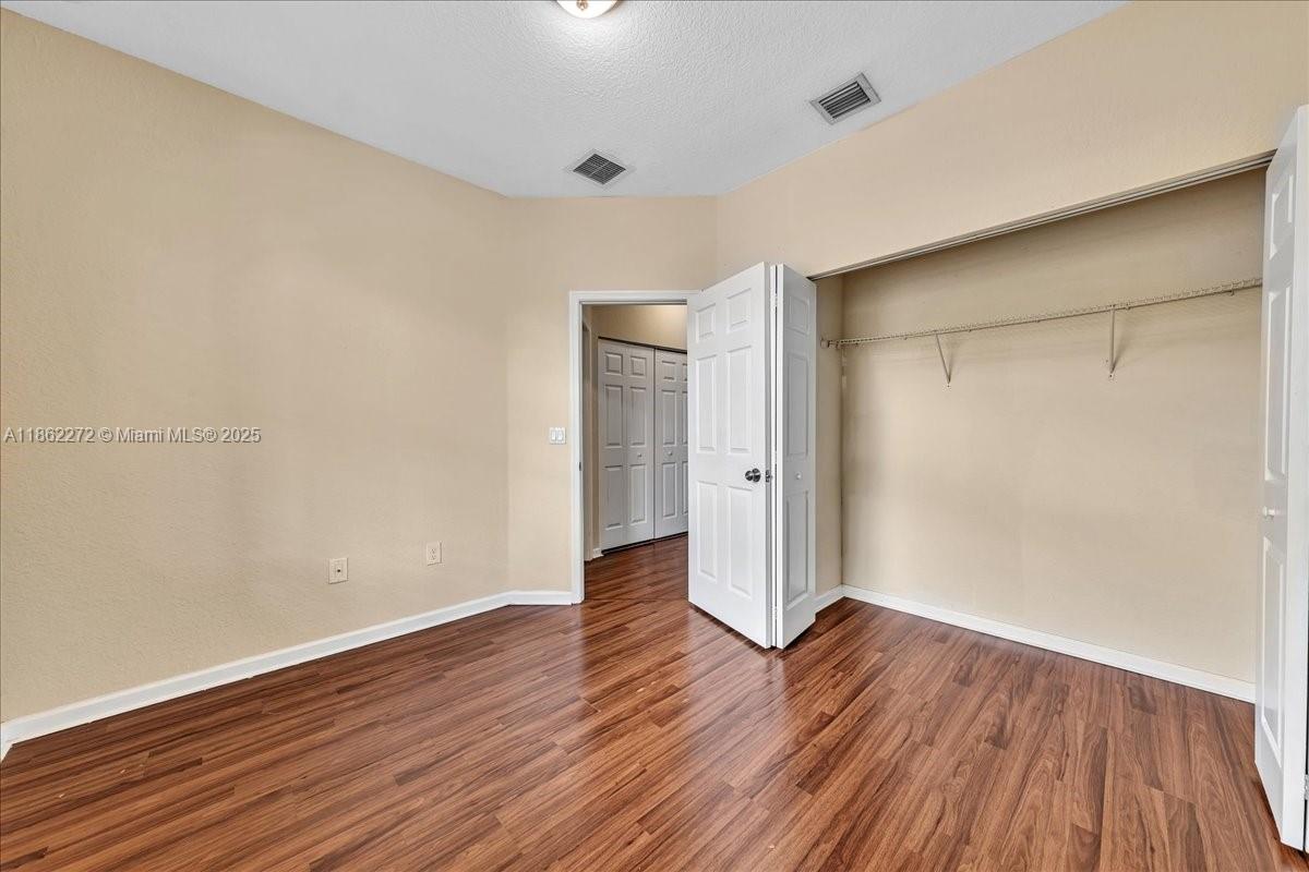 12252 Southwest 25th Court, Unit 1614 Miramar, FL 33025 - Photo 39 of 46 a view of an empty room with wooden floor