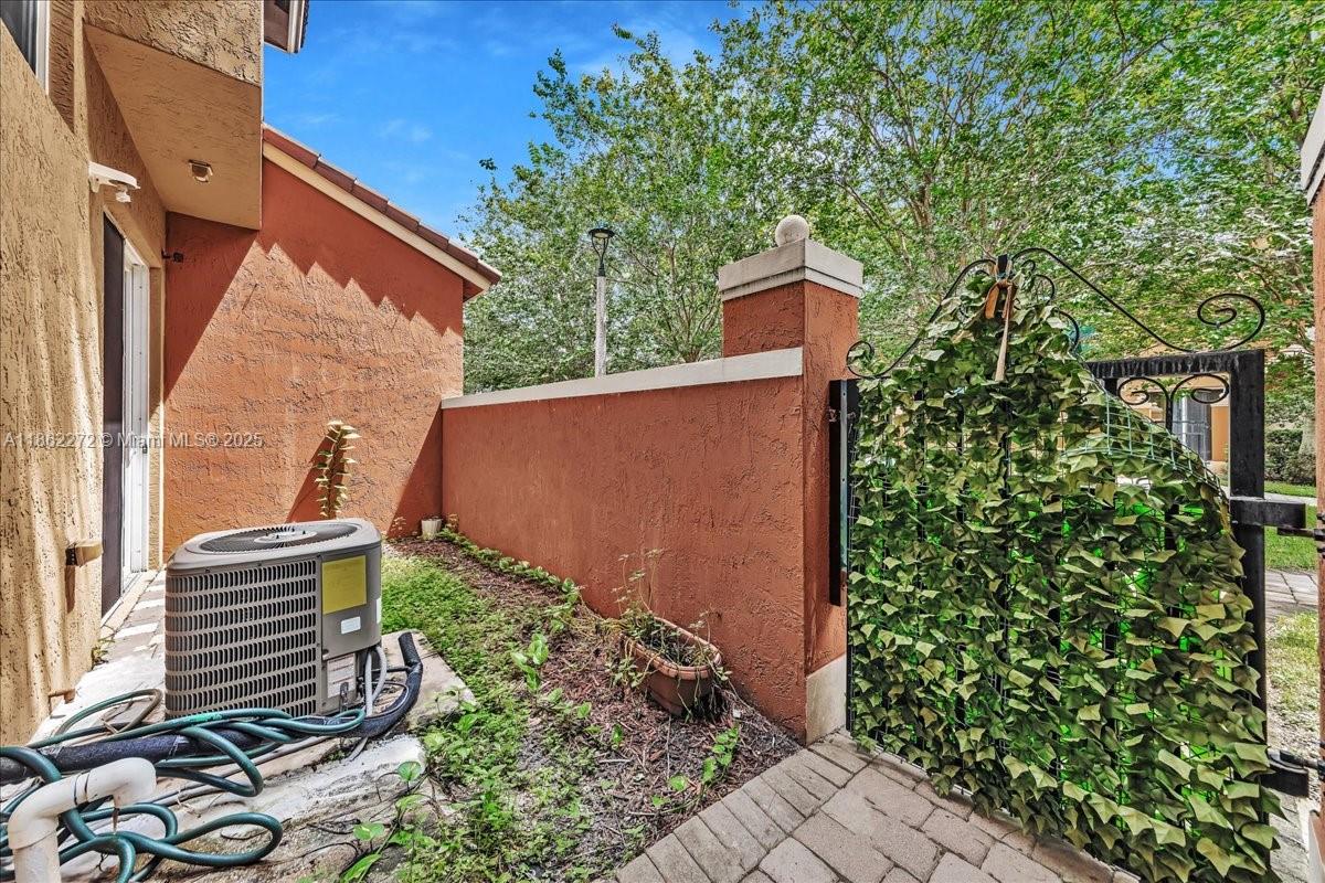 12252 Southwest 25th Court, Unit 1614 Miramar, FL 33025 - Photo 45 of 46 a backyard of a house with lots of green space