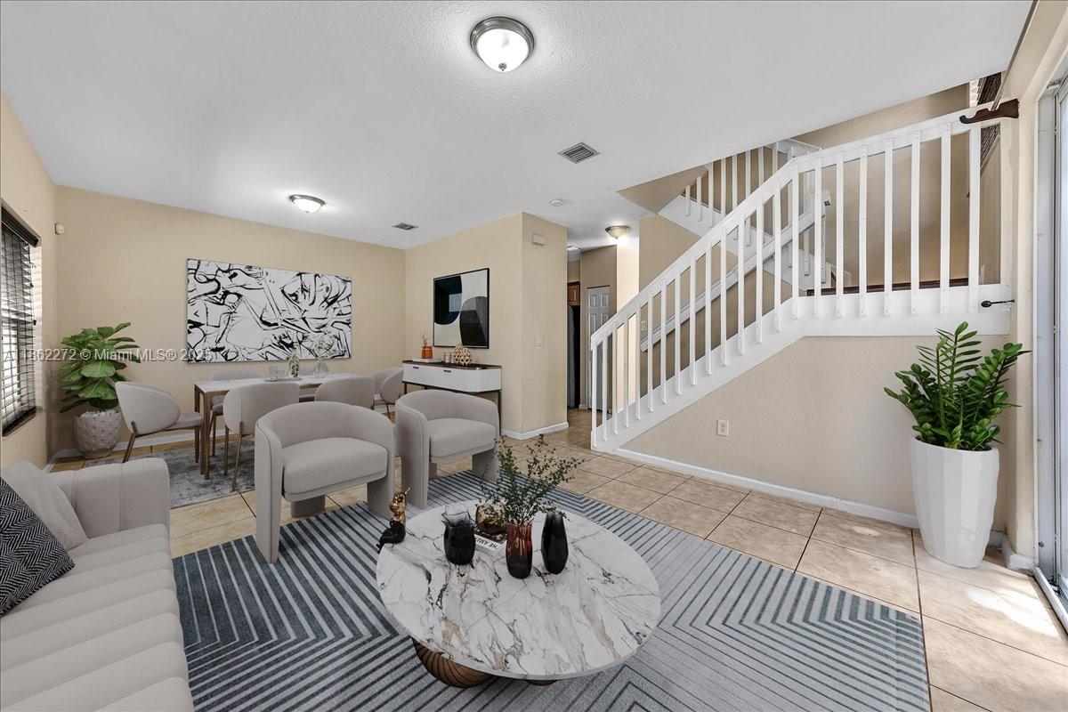 12252 Southwest 25th Court, Unit 1614 Miramar, FL 33025 - Photo 6 of 46 a living room with furniture and wooden floor