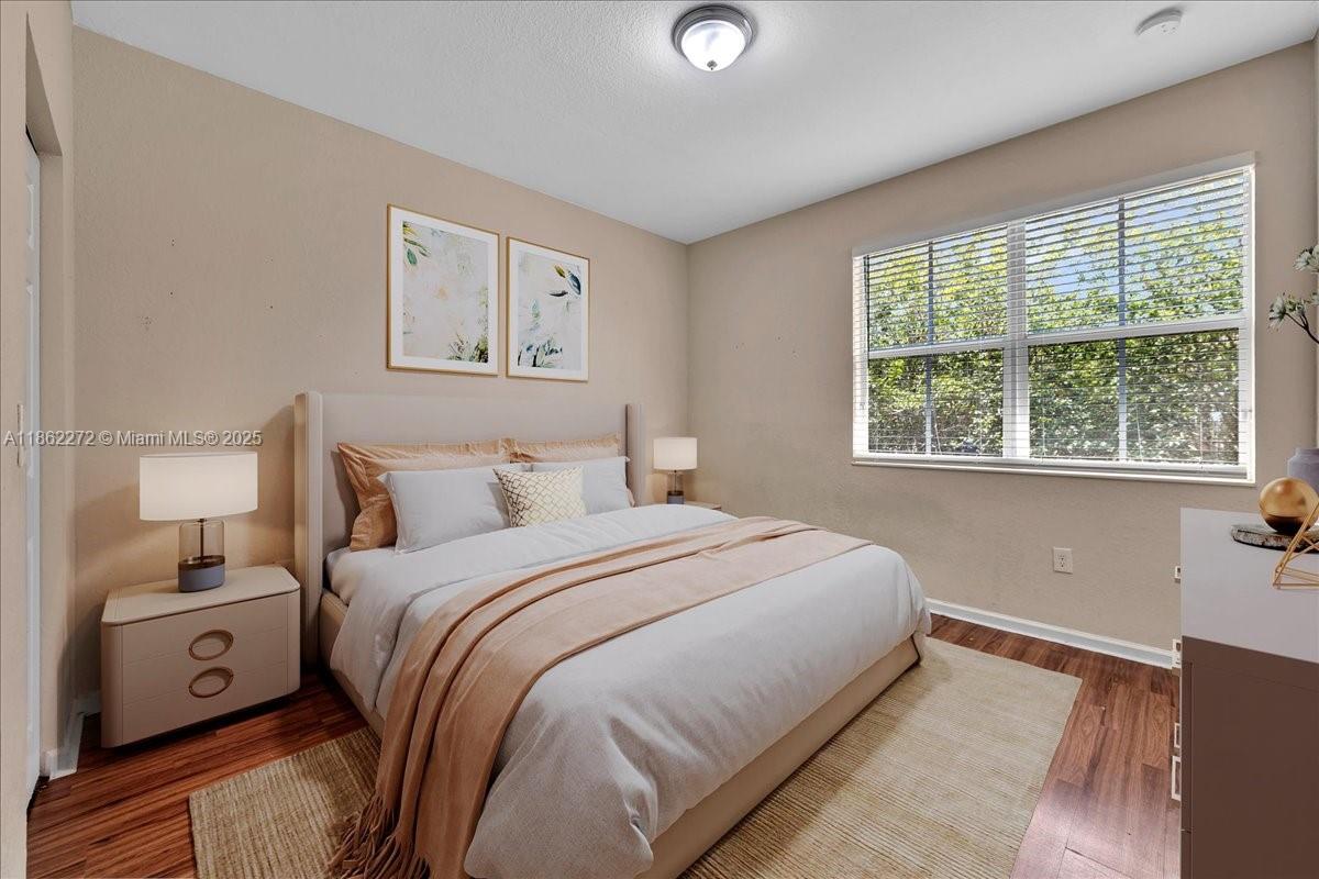 12252 Southwest 25th Court, Unit 1614 Miramar, FL 33025 - Photo 7 of 46 a bedroom with a large bed and a tv