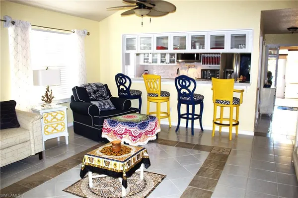 a living room with furniture and floor to ceiling window